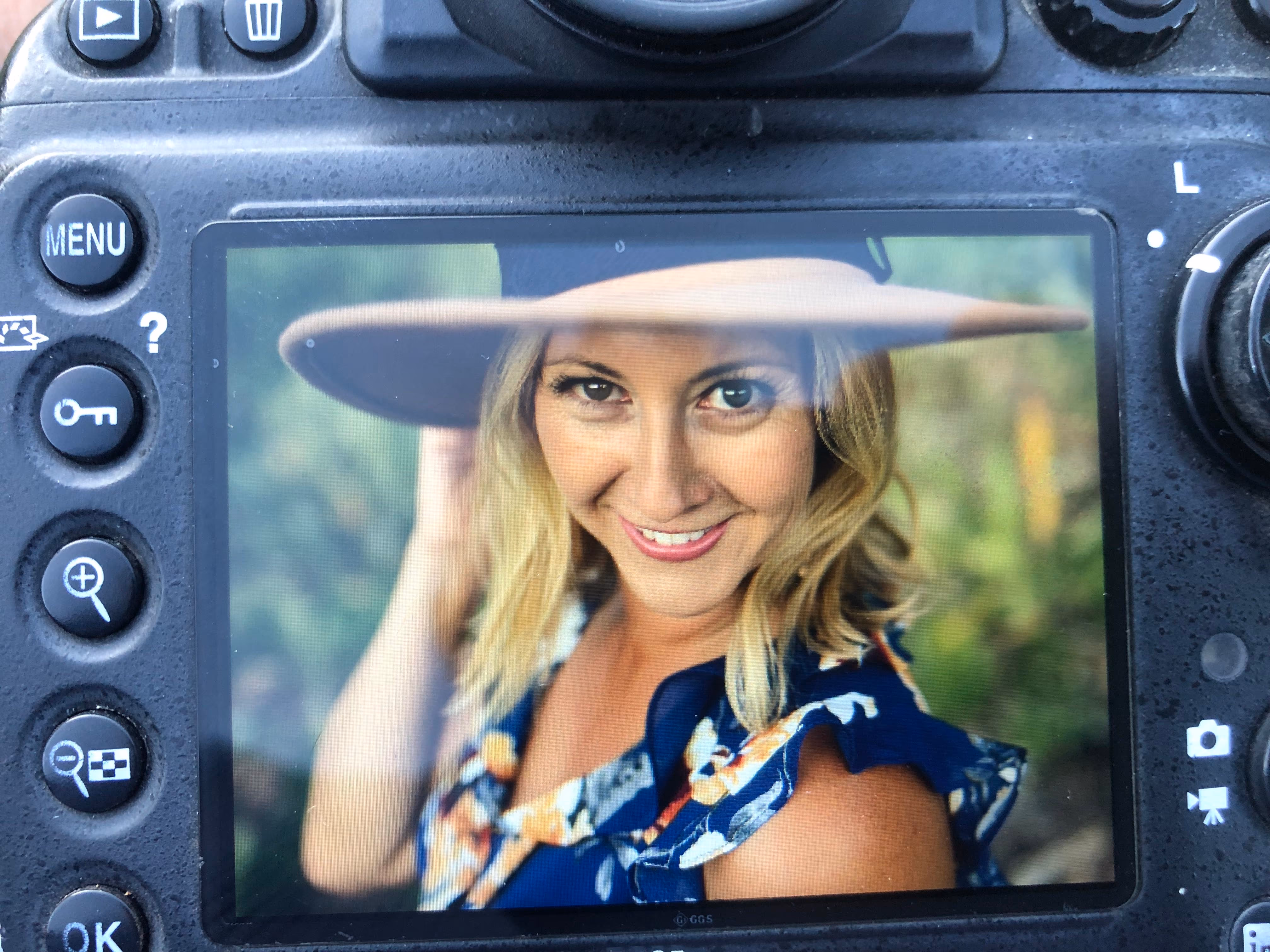 Alicia Cervenka, Bay Area portrait photographer, seen through the back of her camera